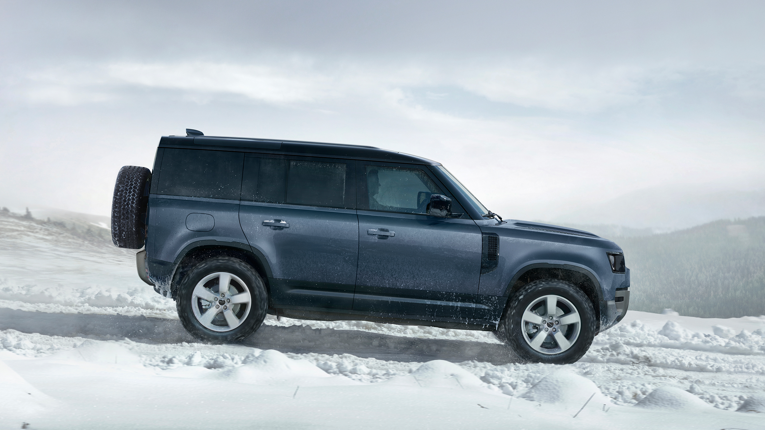 Defender driving on snowy off-road